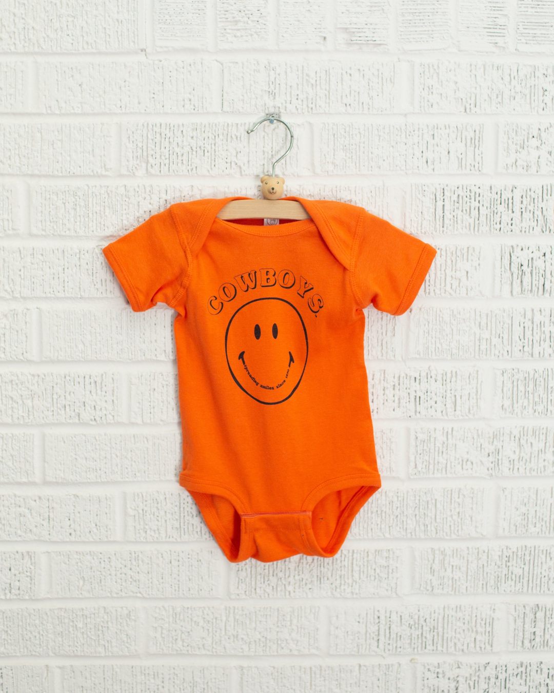 Children's Cowboys Spread Smiles Orange Onesie